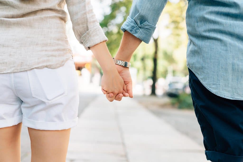 Couple holding hands on a date